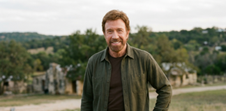 Chuck Norris Dies at 86: Full Story, Career & Truth About Heart Attack Rumors Chuck Norris smiling outdoors in a casual outfit with a scenic background